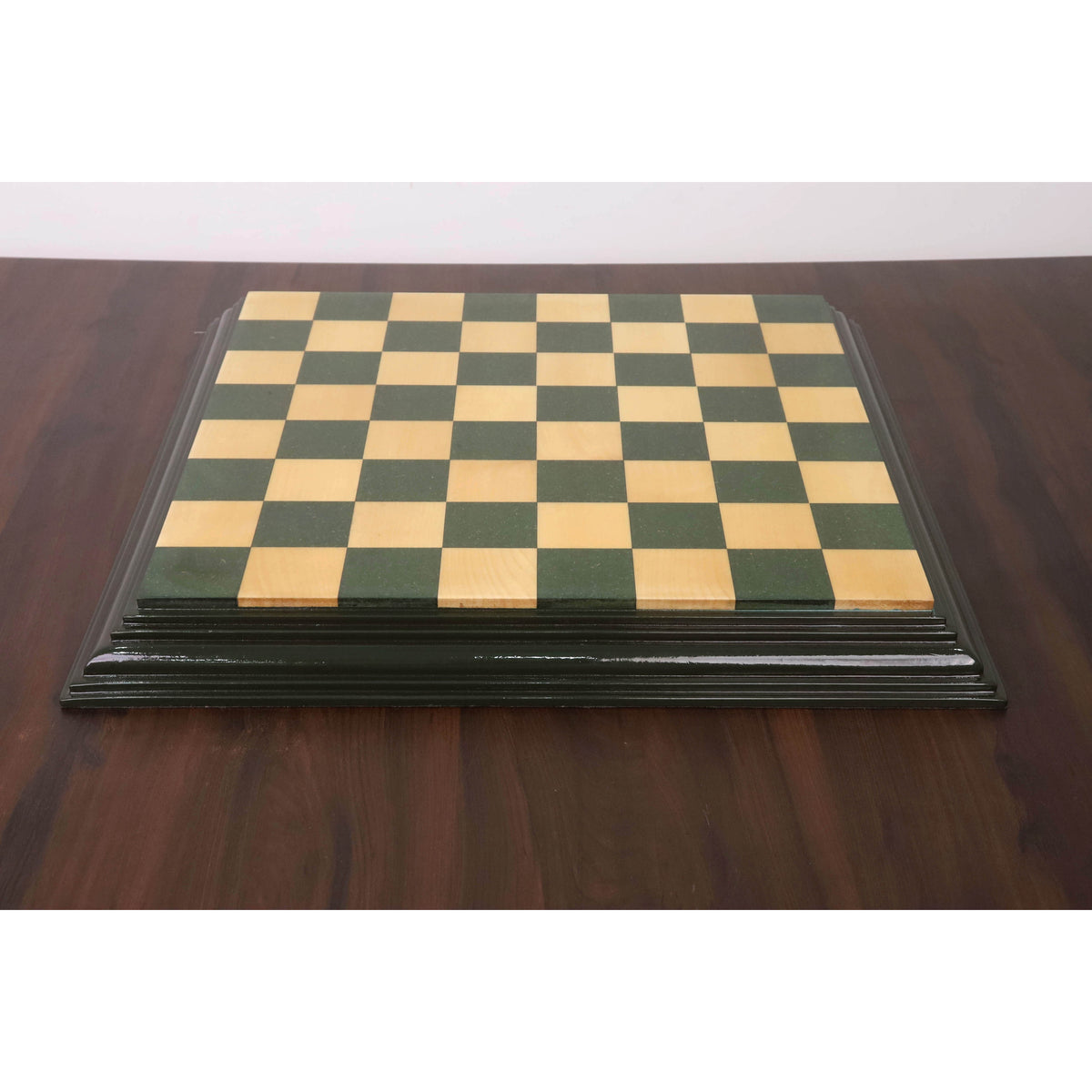 Symmetrical front view of a 21 inch handcrafted green and maple board with decorative edges.