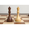 Golden rosewood and boxwood chess queens side by side on a board