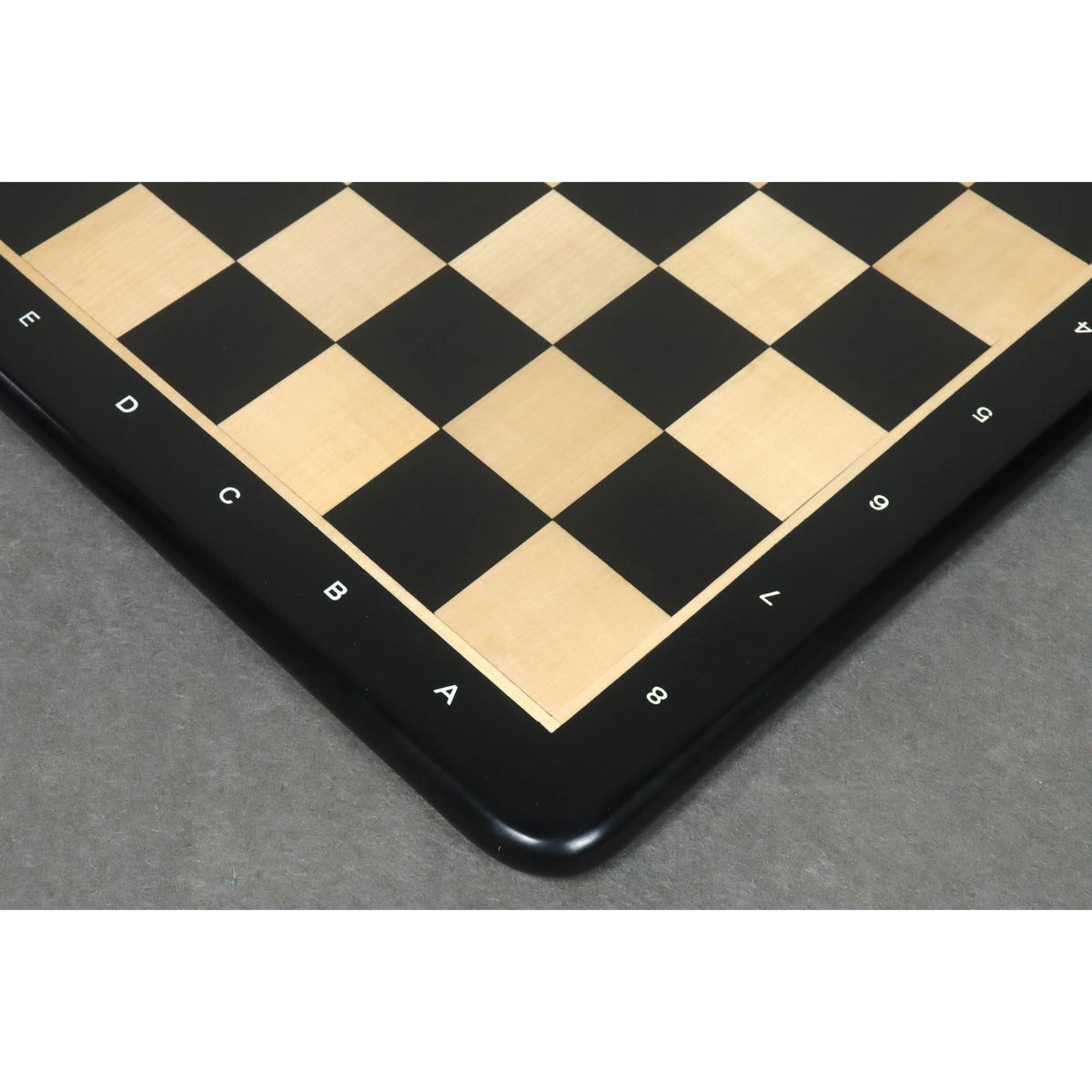 Handcrafted corner detail of a solid ebony and maple wood tournament chess board.