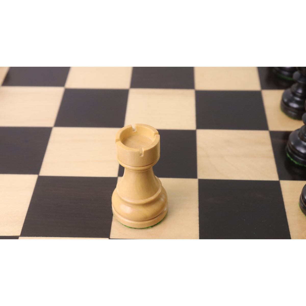 Detailed view of a white boxwood rook from the 3.3" Tournament Staunton chess pieces set.