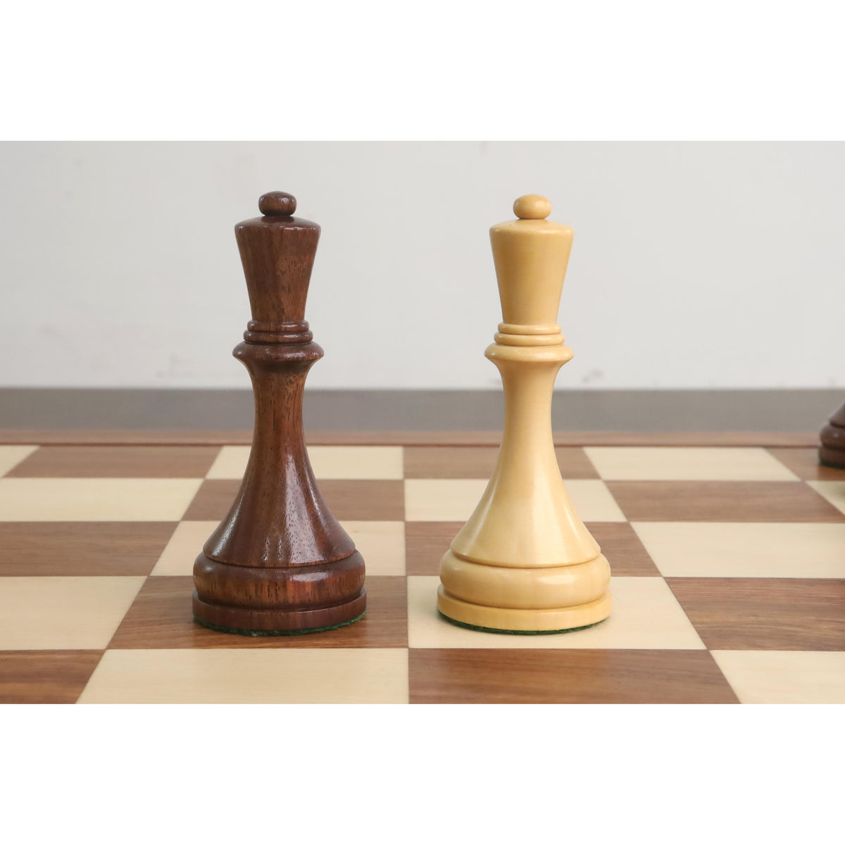 Comparison of a golden rosewood queen and a light wood pawn.