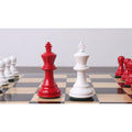 Pro Staunton red and white kings standing center stage on a gloss chessboard.