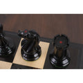 Top view of ebony knight and rook featuring the traditional red crown markings for authenticity.