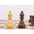 Light boxwood and dark golden rosewood bishops from the 3.3 inch tournament Staunton set on a board.