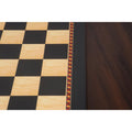 Close-up of the border transition between the ebony edge and the printed playing surface of the chess board.