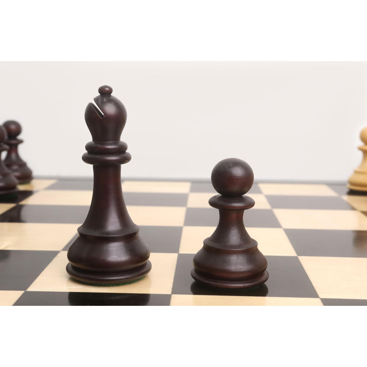 Dark mahogany stained boxwood bishop and pawn pieces.