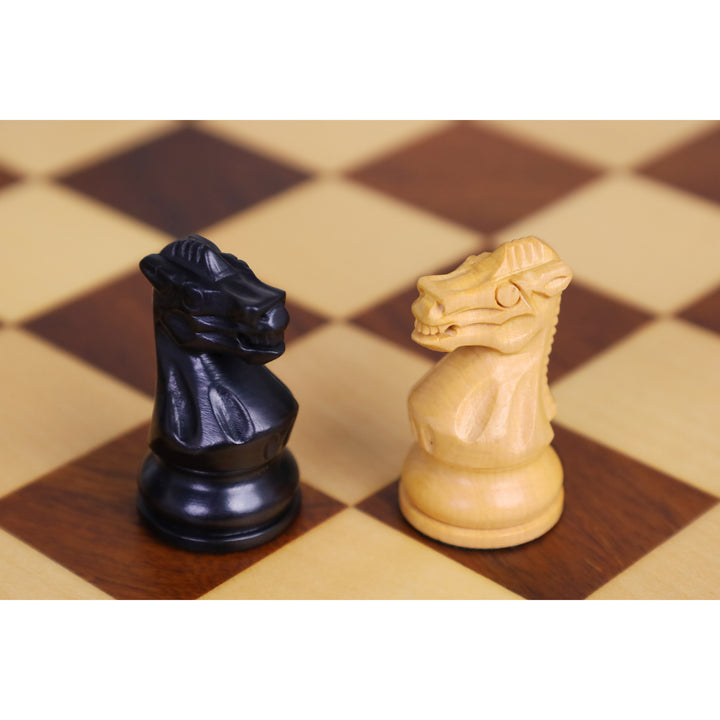 Finely hand-carved ebonised boxwood and boxwood knight chess pieces on a wooden board.