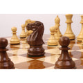 Close-up of a golden rosewood knight piece on a Monarch series wooden chess table.