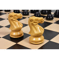 Close-up of finely detailed natural boxwood Staunton knight chess pieces.