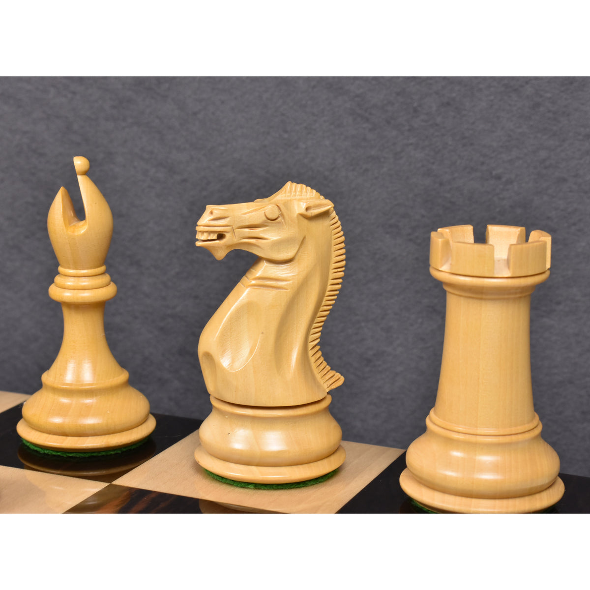 Detailed carving of the bishop, knight, and rook in the Sleek Staunton luxury chess set.