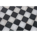 Close-up texture of alternating black and white onyx marble squares.