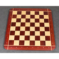 Full top-down view of the 23" tournament-size Bud Rosewood and Maple chessboard on a dark textured surface.