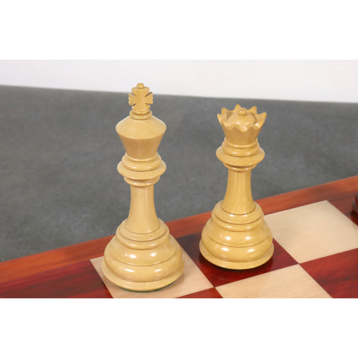 Premium handcrafted boxwood king and queen chess pieces showcasing intricate finial details.