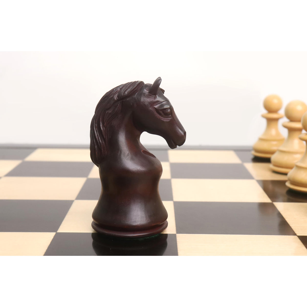 Side view of a dark mahogany stained boxwood knight, Piatigorsky Cup model.