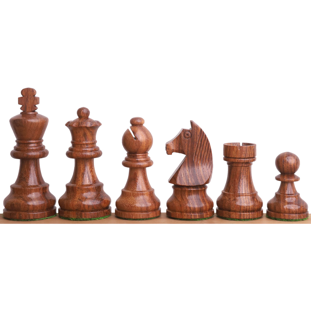 A collection of handcrafted golden rosewood chess pieces arranged for display.