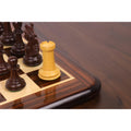 Close-up of a Boxwood Rook from the 3.9" Heritage Series Staunton set positioned on the corner square of a glossy chessboard.