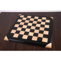 Wide angle view of the 21 inch Ebony and Maple Wood Luxury Chessboard with raised tiles on a mahogany table.