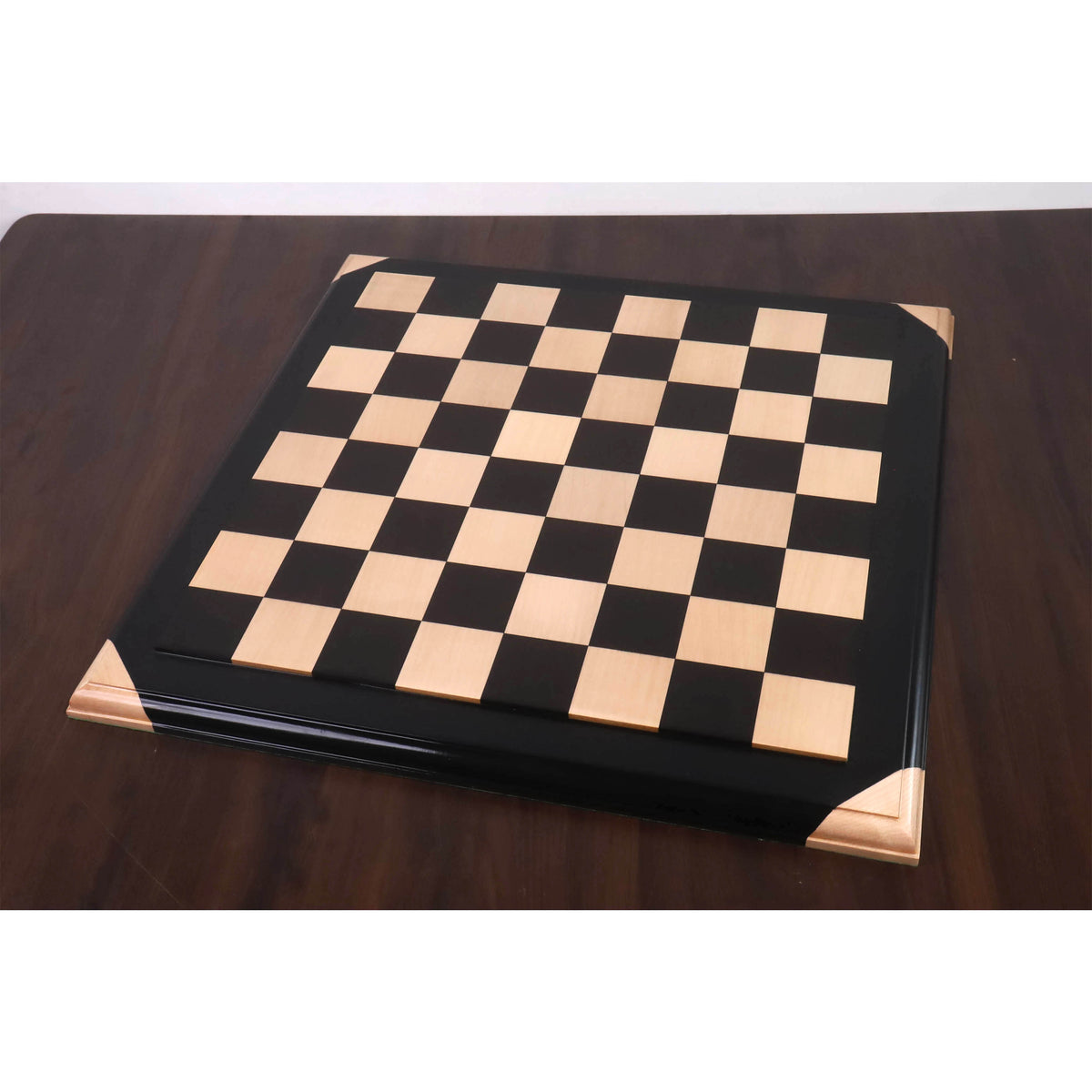 Wide angle view of the 21 inch Ebony and Maple Wood Luxury Chessboard with raised tiles on a mahogany table.