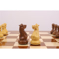 Close-up of the 4.1" King and Queen Pro Staunton weighted pieces in Golden Rosewood on a glossy chess board.