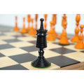 Ebony Pre-Staunton rook on a wooden board.