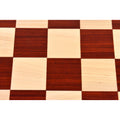 Close-up of alternating light maple and dark bud rosewood wood chess board squares.