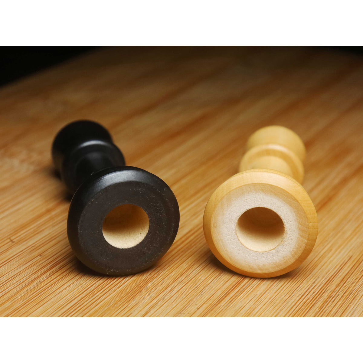Detailed view of the hollowed base of Craftsman Staunton chess pieces, designed for Chessnut Air sensors.