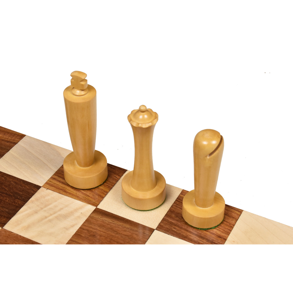 High-angle view of minimalist boxwood king, queen, and bishop pieces on a checkered board.