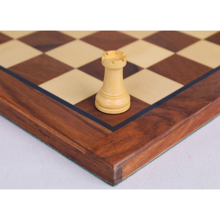 Detailed view of a classic boxwood rook chess piece resting on a maple and walnut board.