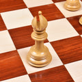 Premium natural boxwood bishop piece showcasing detailed mitre cuts on a glossy chessboard.