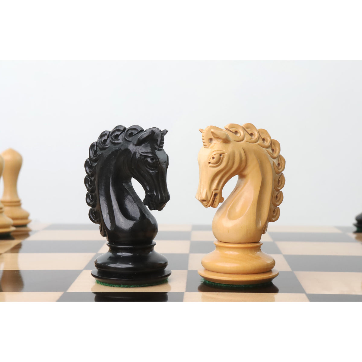 Black and ivory Avant Garde chess knights positioned on the board.