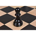 Natural ebony pawn piece from the 4.6 inch Prestige Luxury Staunton set on a wooden chessboard.