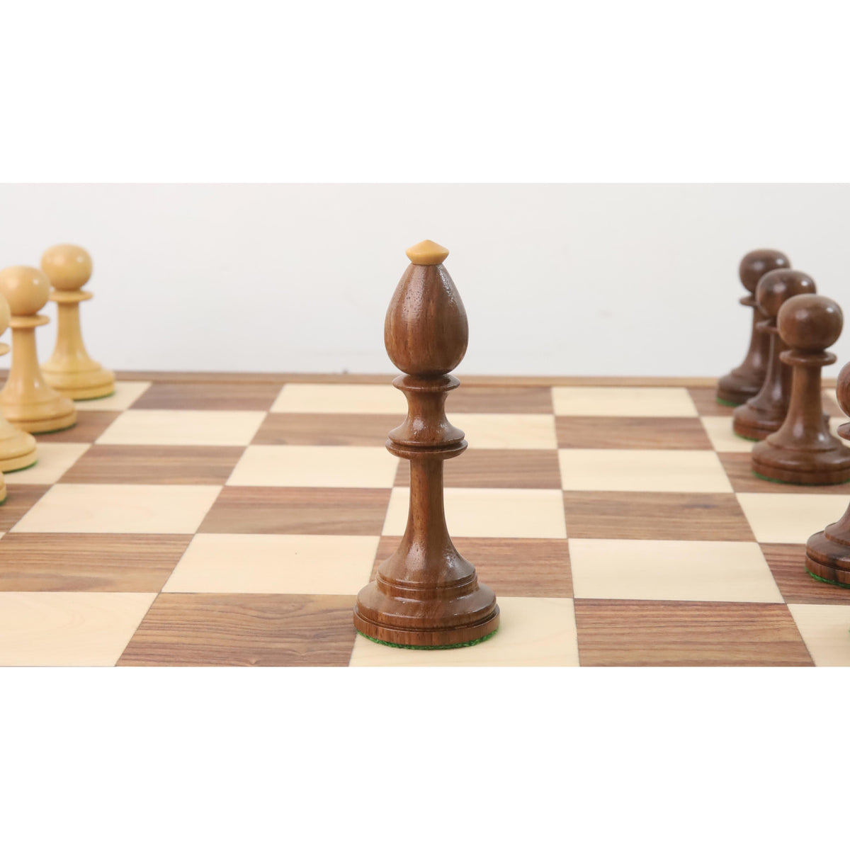 A single dark golden rosewood bishop piece centered on a chessboard.