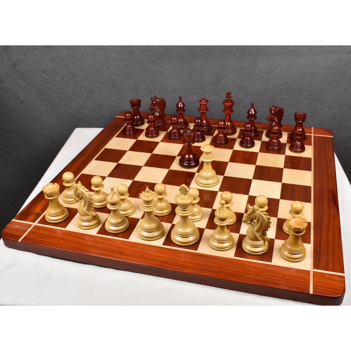 The complete Napoleon Luxury Staunton chess set in Bud Rosewood and Boxwood is set up on the 23" wooden board.