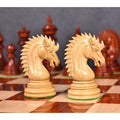 Two light Bud Rosewood Dragon Knights face each other on a wooden chessboard, showcasing their intricate carving.