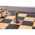 Single grey metallic pawn piece on a wooden board.