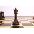 A beautifully crafted dark rosewood queen from the 3.5" Monolith miniature chess set on a board.