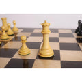 Fine boxwood Queen and pawn showcasing detailed crenellations from the luxury Staunton chess set.