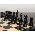 Polished black Pro Staunton chess pieces neatly arranged on a 17 inch ebony chess board.