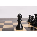 Close-up of a black English Dublin Bishop piece positioned on a wooden chess board.