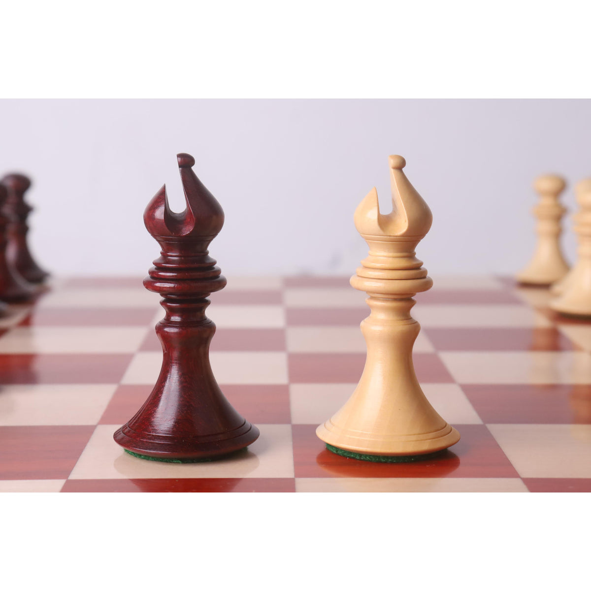 Detailed view of dark Bud Rosewood and light Boxwood Staunton bishops.