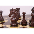 Detailed close-up of a carved dark Rosewood Knight from the 3.9" Heritage Series Staunton set, surrounded by pawns on a chessboard.