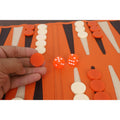 Close-up of an orange backgammon checker, highlighting the premium finish.