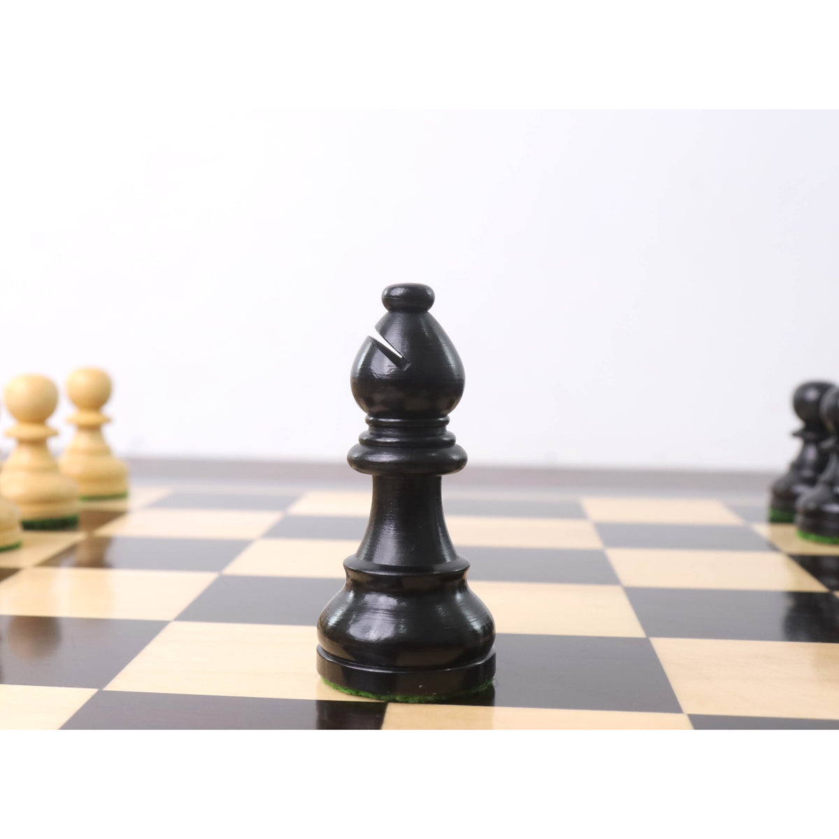 Close-up of a black bishop from the 3.3" Tournament Staunton ebonised boxwood chess pieces set.
