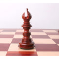 Handcrafted bud rosewood Bishop chess piece featuring a deeply carved miter cut on a chessboard.