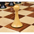 A single natural boxwood pawn from the Herman Ohme chess set on a board.
