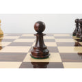 A sharp close-up of a single dark rosewood pawn centered on a chessboard square.