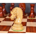 A close-up of the detailed light Bud Rosewood Dragon Knight on a wooden chessboard, facing left.