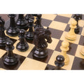 Detailed view of a handcrafted ebony Heritage Series Staunton knight on a chess board.