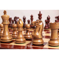 Light Pro Staunton knight and king pieces on a wooden chessboard.
