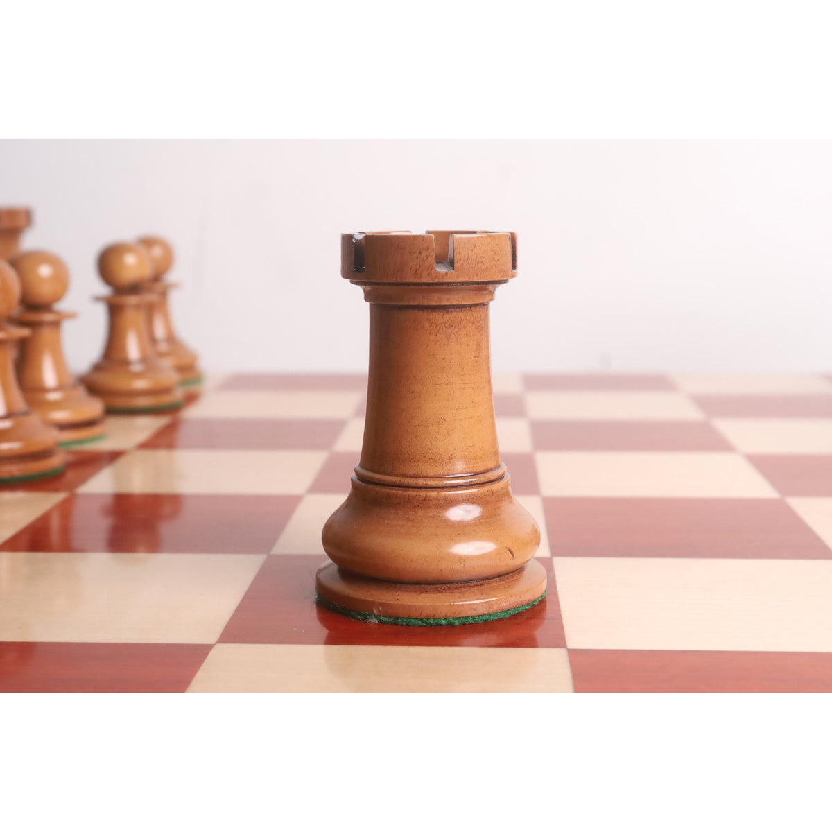 Antiqued boxwood rook piece showing traditional staunton craftsmanship.